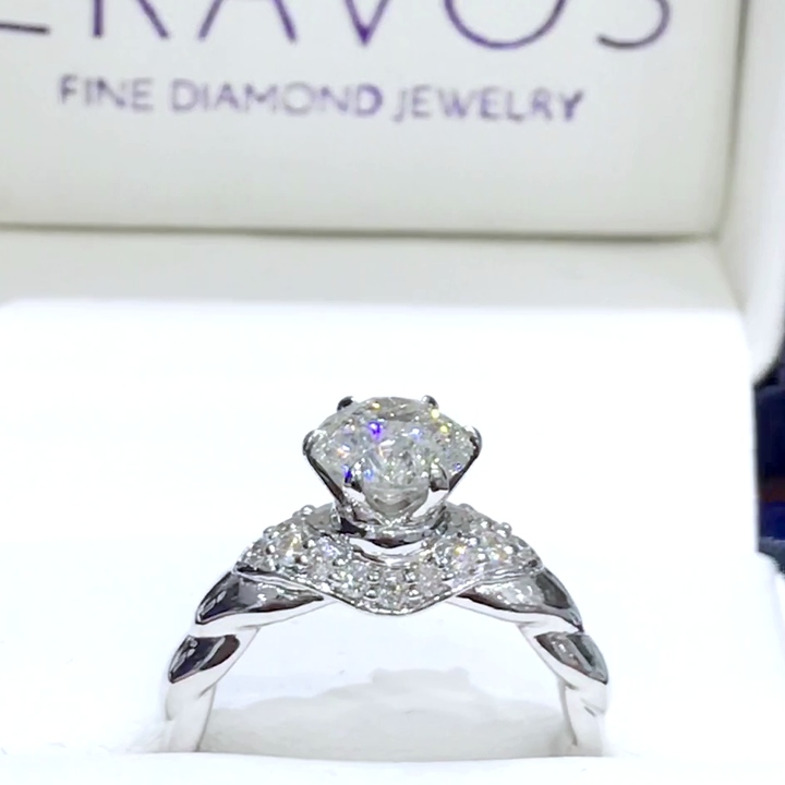 18kt White Gold Engagement Ring with 1.8 carat lab diamond at the center (Color: E | Clarity: VS1 | Round Cut) and natural E / VVS grade Setting Diamonds. Twist Band setting with Diamonds set to create a Collar.